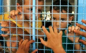 Typical UNRWA propaganda picture suggesting children in Gaza imprisoned by Israel. The reality is that this picture is of children inside an UNRWA school in Gaza. The chain fence belongs to UNRWA.