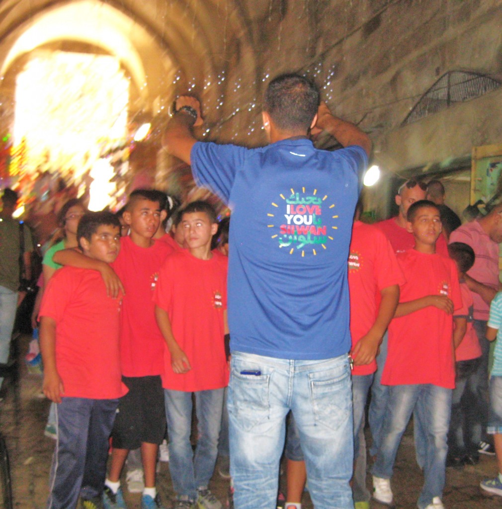 Note the writing on the back of the leader's blue shirt: "I love Silwan." Each of the red shirts that the boys were wearing said the same thing. 
