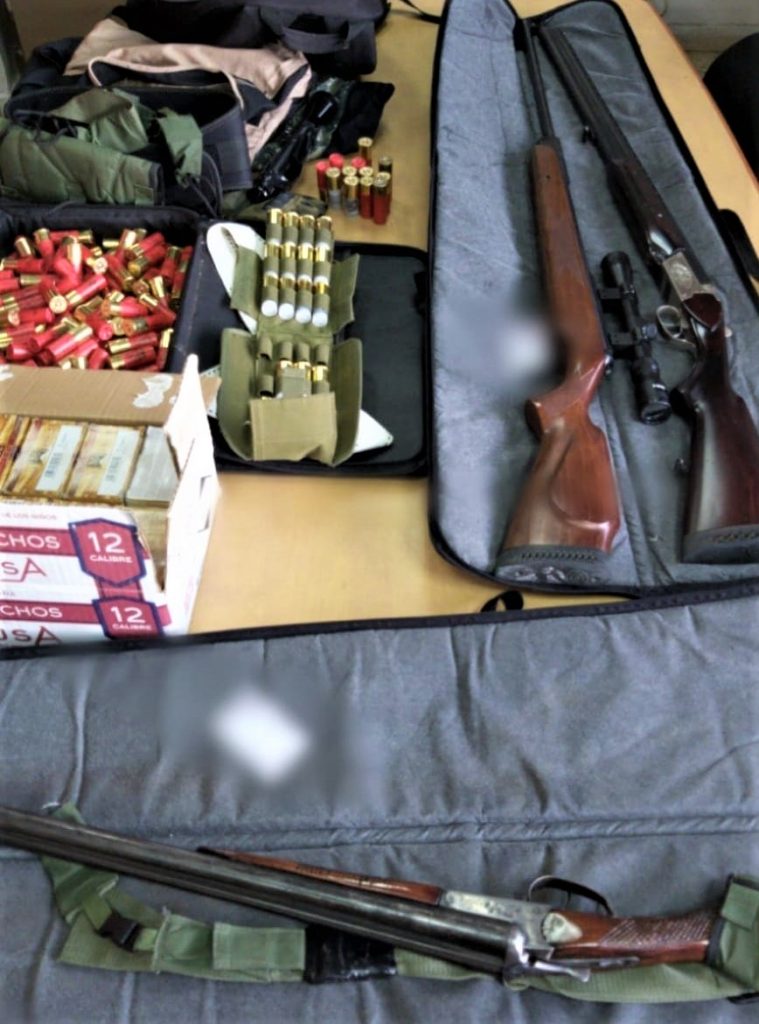 A sniper rifle, shotguns, and boxes of ammunition were seized at one location (photo: Israel police).