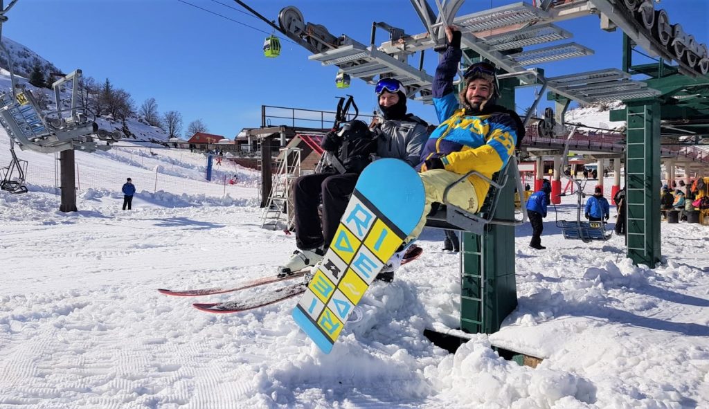 A skier and a snowboarder on the Mt. Hermon lift this morning.