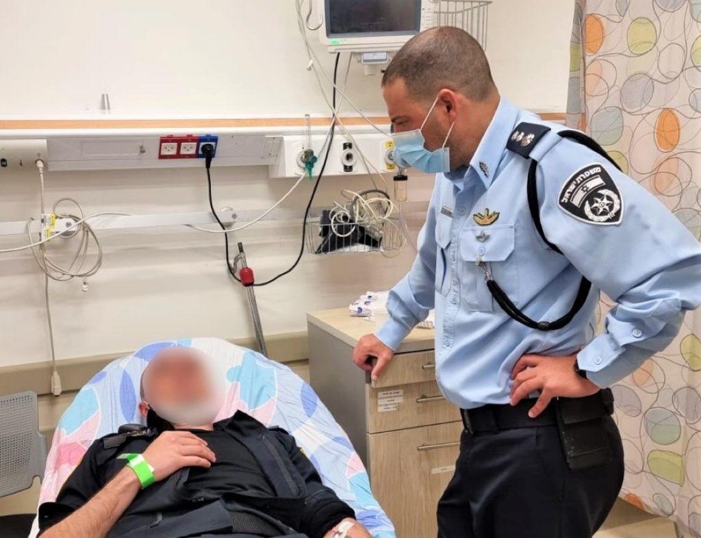 A fellow officer visits his wounded colleague.