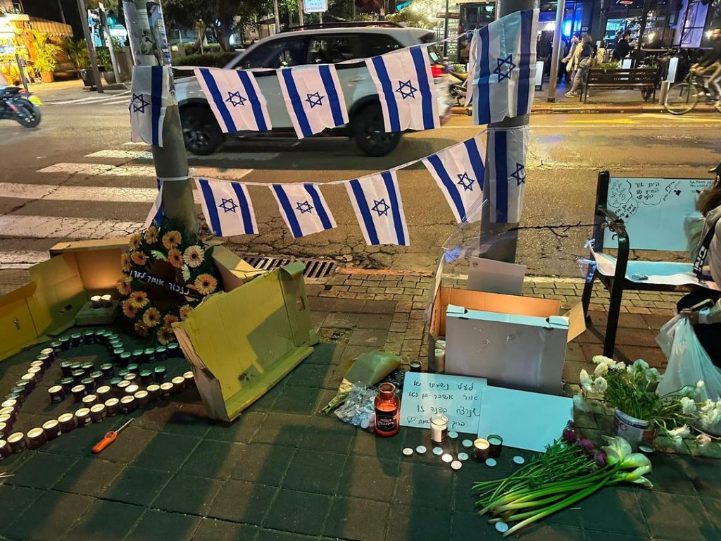 When news of Or's death was made public last night, a makeshift memorial began to materialize at the place on Dizengoff where he was shot.
