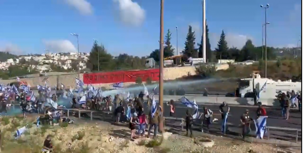 A small group of anarchists blocked Highway 1 near the Hemed interchange for about an hour this morning until a police water cannon dispersed them.