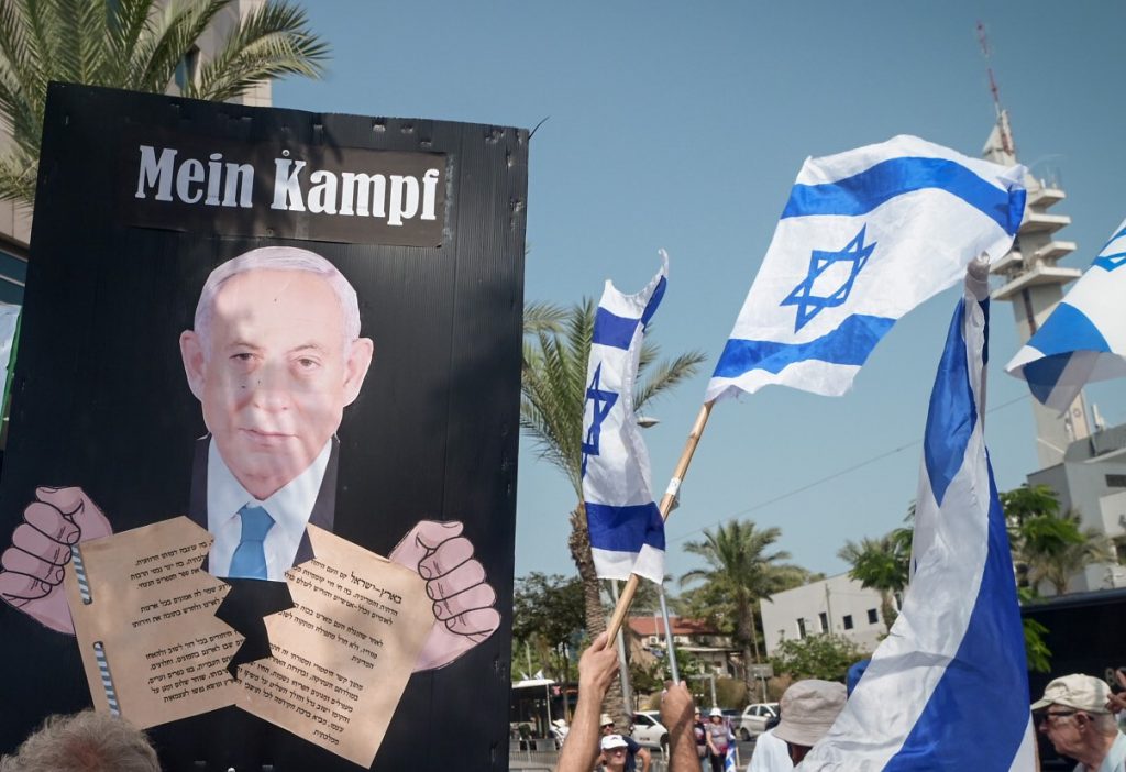 The latest placard being held at leftist demonstrations. This one (and other copies) was held Saturday night in Tel Aviv.